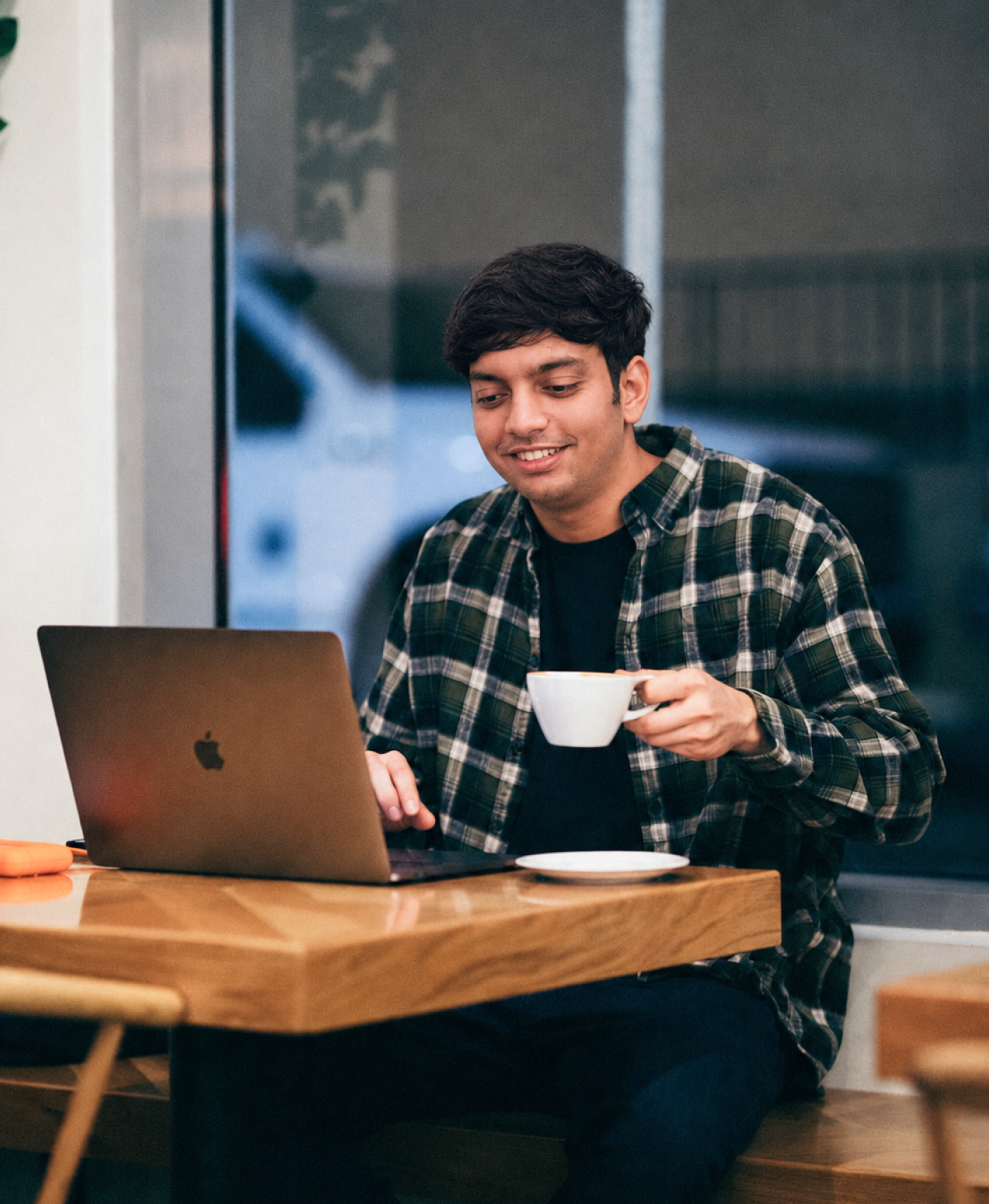 Anivesh working on a laptop in a cafe