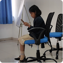 Student seated at a whiteboard, focused on the HydroAR app during an in-depth testing session
